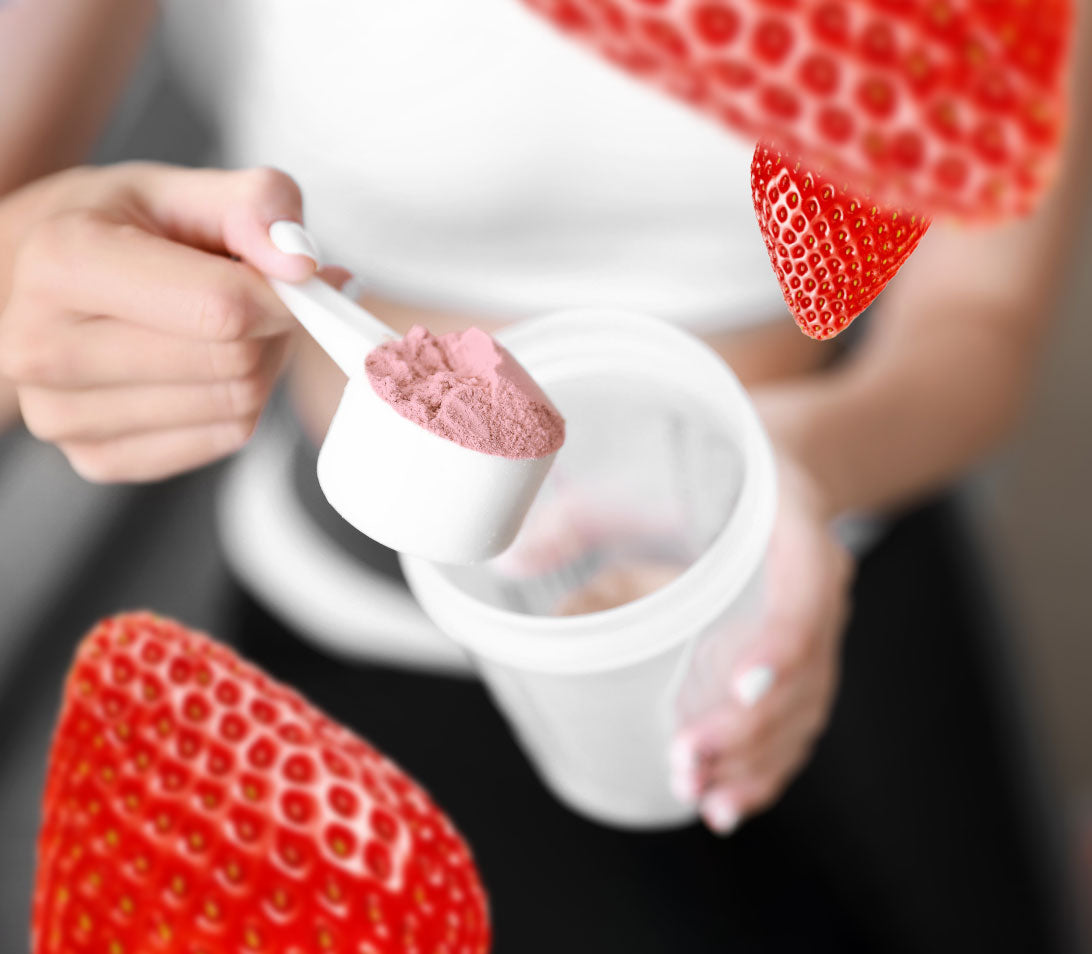 Woman scooping cluster dextrin based Wolf8 powder drink mix into a blender bottle.